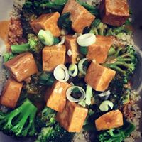 Image of a vegetable dish with cooked broccoli, carrots, and green onions.